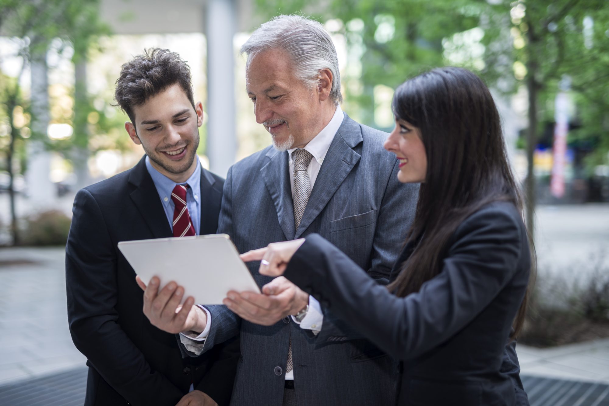 Oppium Company By Inventiva Creative Studio Group Of Business People Using A Digital Tablet